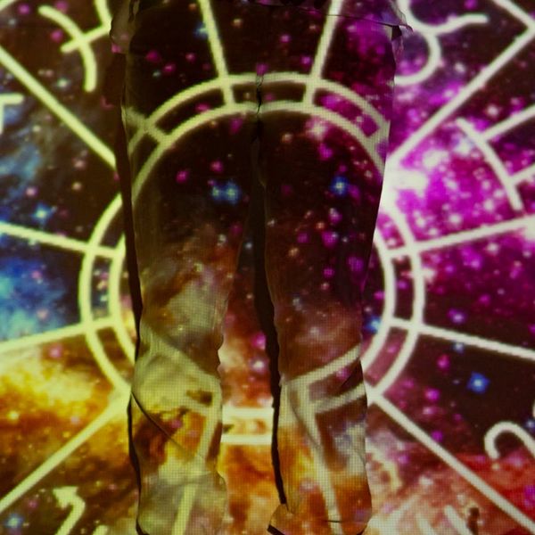 Silhouette of a person in a powerful yoga pose against a vibrant sunrise.